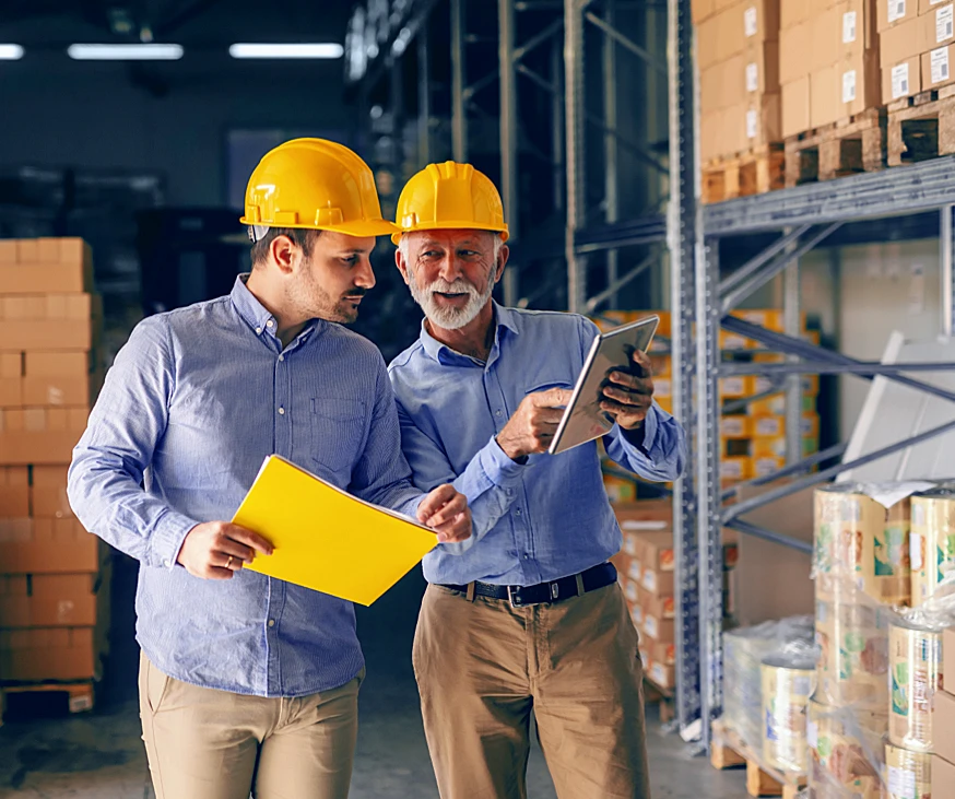 two men in warehouse with hardhats