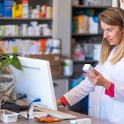 woman pharmacist looking at computer